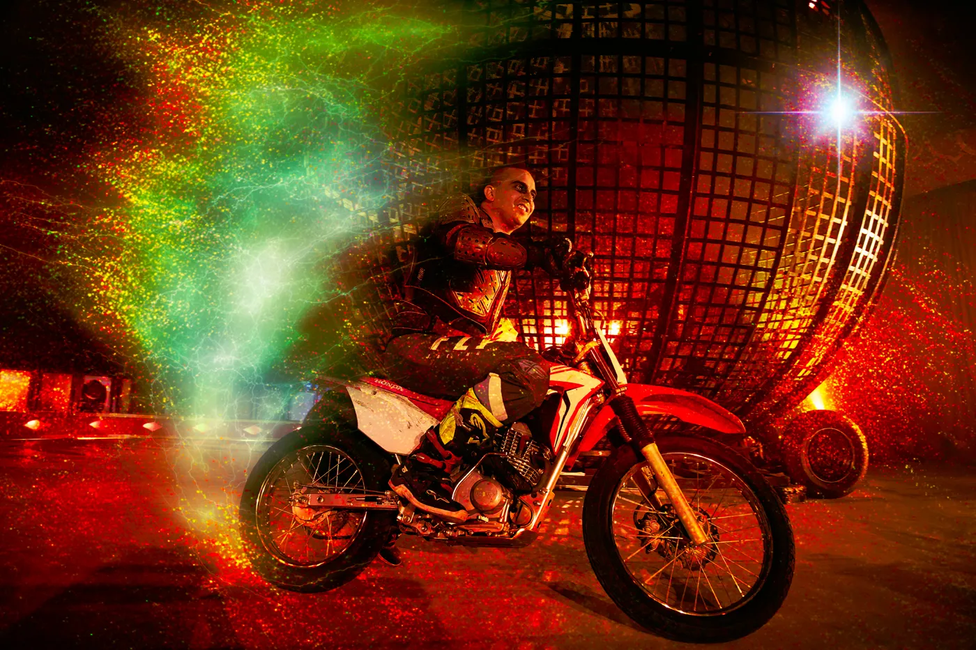 A motorbike rider in front of the steel globe, in a Halloween-styled promotional image